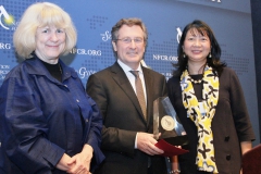 Dr. Michael Hall receiving award from last year’s winner, Dr. Mary-Claire King, and Dr. Sujuan Ba from NFCR
