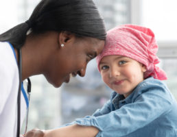 Female doctor comforts her young patient who has cancer Female doctor comforts her young patient who has cancer
