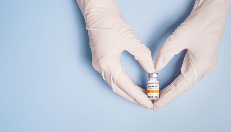 Doctor's hand in heart showing coronavirus vaccine