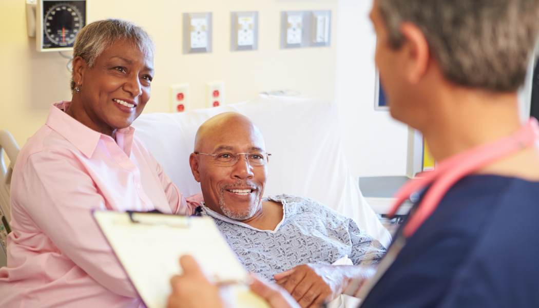 Blog Feature Image eye cancer Husband and Wife look hopeful speaking to Doctor in hospital