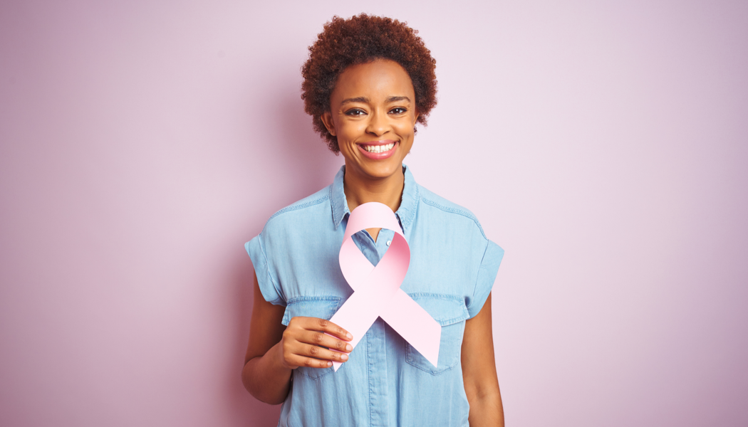 tnbc new hope woman holding pink ribbon for breast cancer awareness
